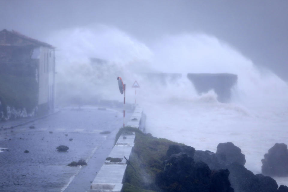 Waves crash on a seafront road in Horta, in the Portuguese island of Faial, Wednesday, Oct. 2, 2019. Hurricane Lorenzo lashed the mid-Atlantic Azores Islands with heavy rain, powerful winds and high waves Wednesday, but initial reports said it caused only minor damage. (AP Photo/Joao Henriques)