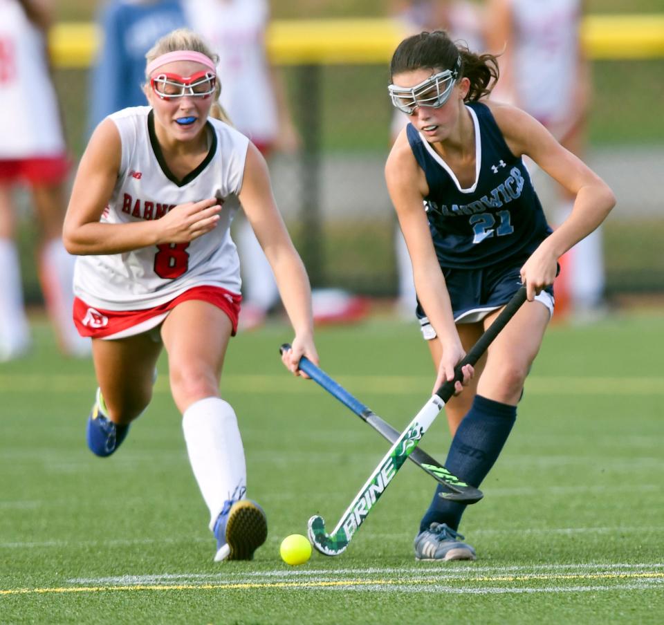 Penny Baroni of Barnstable reaches in an attempt to stop a drive by Jordan Quinn of Sandwich.