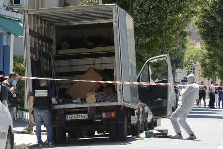 French investigating police conduct a search for clues around a truck, the day after a heavy a truck ran into a crowd at high speed killing scores and injuring more who were celebrating the Bastille Day national holiday, in Nice, France, July 15, 2016. REUTERS/Jean-Pierre Amet