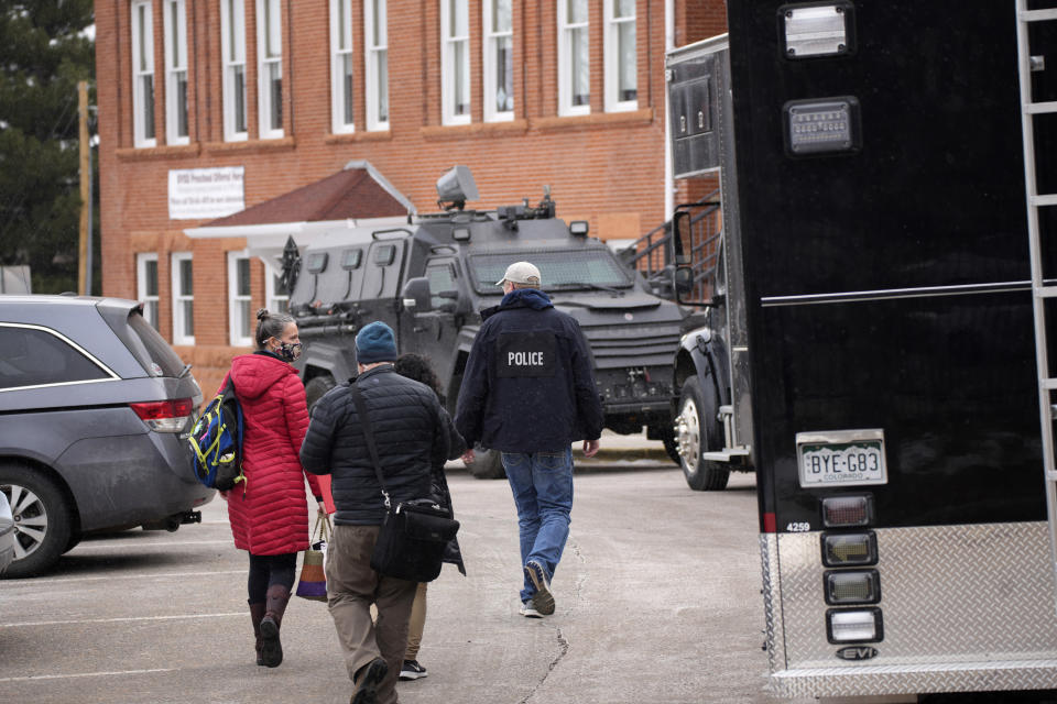 FILE - Police vehicles sit in front of University Hill Elementary School across from the campus of the University of Colorado after Matthew Harris, accused of making violent threats against the college as well as the University of California, Los Angeles, was taken into custody following a standoff at his Boulder apartment complex Tuesday, Feb. 1, 2022, in Boulder, Colo. A trail of red flags about his behavior toward women followed Harris, a former lecturer at UCLA, on an academic journey that took him to three of the nation's most prestigious universities — Duke, Cornell and then UCLA. (AP Photo/David Zalubowski, File)