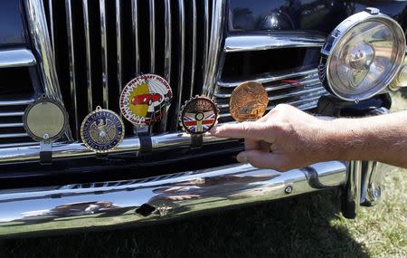 New owner John Yosgott poses with his 1959 Riley Saloon at the Mecum car auction in Monterey, California, August 16, 2014. REUTERS/Michael Fiala