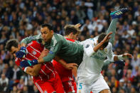 Soccer Football - Champions League Semi Final Second Leg - Real Madrid v Bayern Munich - Santiago Bernabeu, Madrid, Spain - May 1, 2018 Real Madrid's Keylor Navas punches clear of Raphael Varane and Bayern Munich's Mats Hummels REUTERS/Kai Pfaffenbach