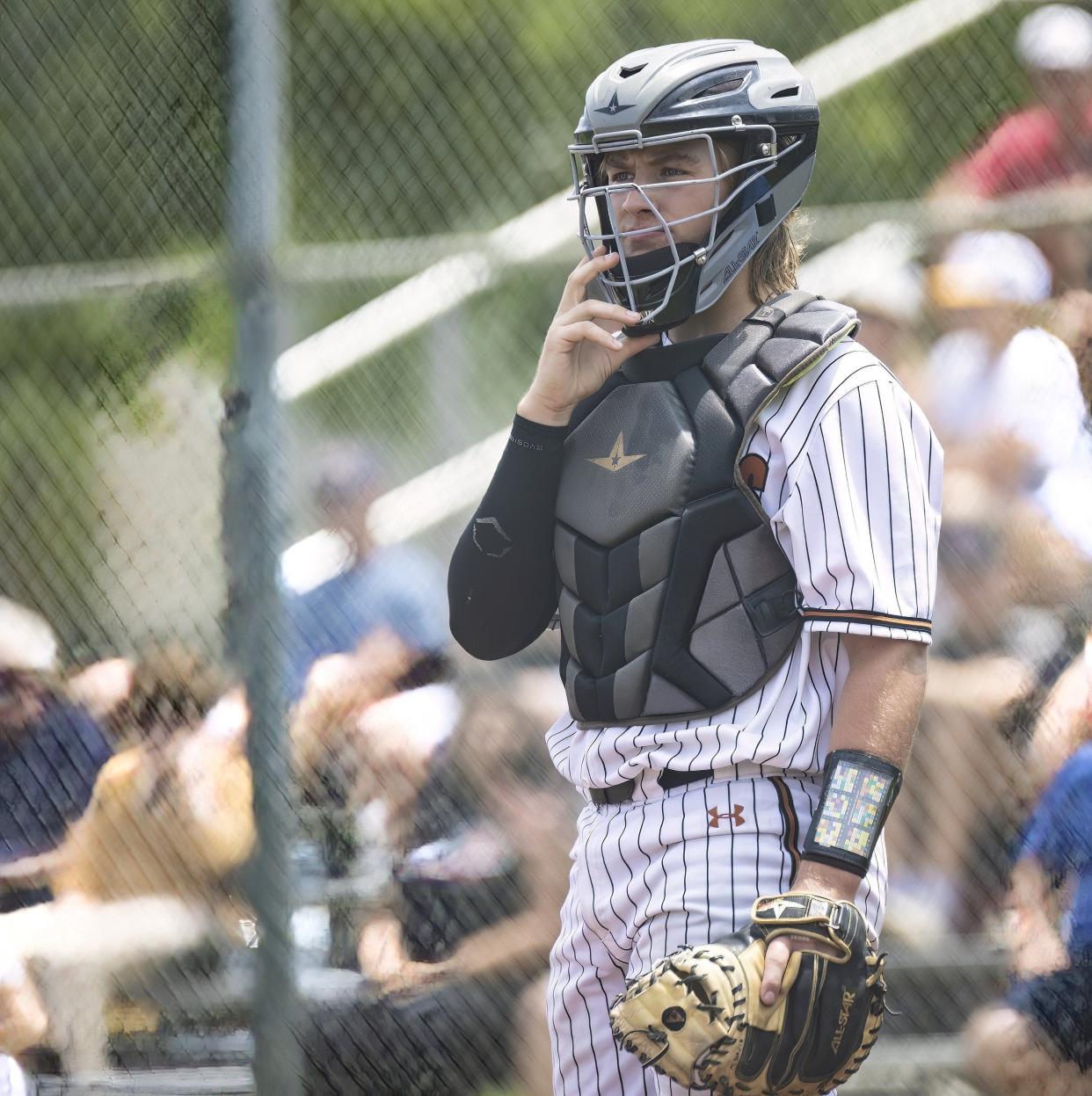Westwood Warriors catcher Mike Davis (22) looks towards the dugout for a pitching signal to pass to the pitcher on during the fifth inning against the Lake Travis Cavaliers at the Bi-district 6A baseball playoff on Friday, May 6, 2023, at Westwood High School.