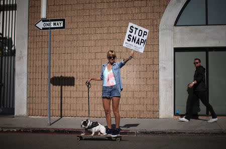 A woman protests outside a Snap Inc. office in Venice Beach as locals demonstrate on the street over the company moving into the beach community in Los Angeles, California, U.S. March 2, 2017 . REUTERS/ Lucy Nicholson