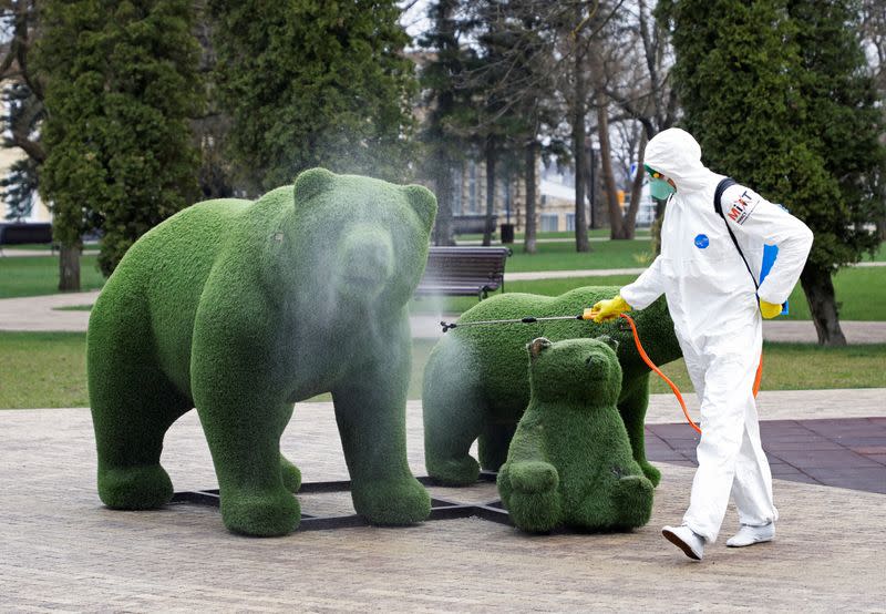 A specialist sprays disinfectant on a street installation in Stavropol