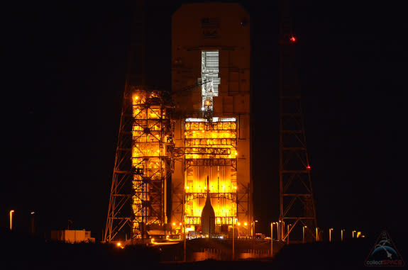 NASA's first space-bound Orion capsule is seen in silhouette, set against the pad lights at Cape Canaveral Air Force Station’s Space Launch Complex 37B in Florida on Wednesday, Nov. 12, 2014.