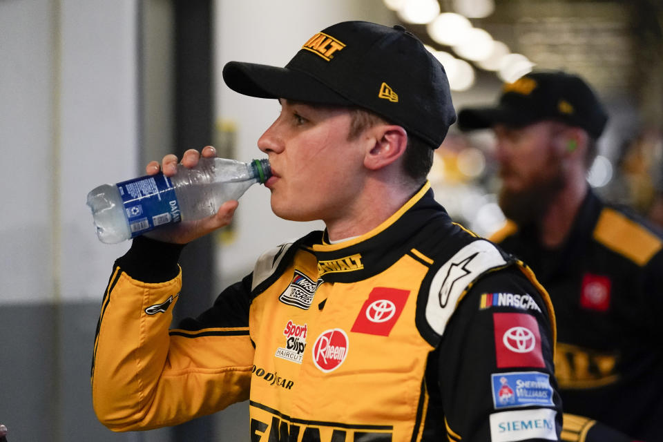 Christopher Bell takes a break in his garage during NASCAR Daytona 500 auto race practice at Daytona International Speedway, Friday, Feb. 18, 2022, in Daytona Beach, Fla. (AP Photo/John Raoux)