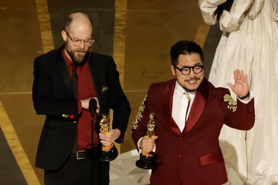 Daniel Scheinert and Dan Kwan accept the Oscar for Best Original Screenplay for "Everything Everywhere All at Once"