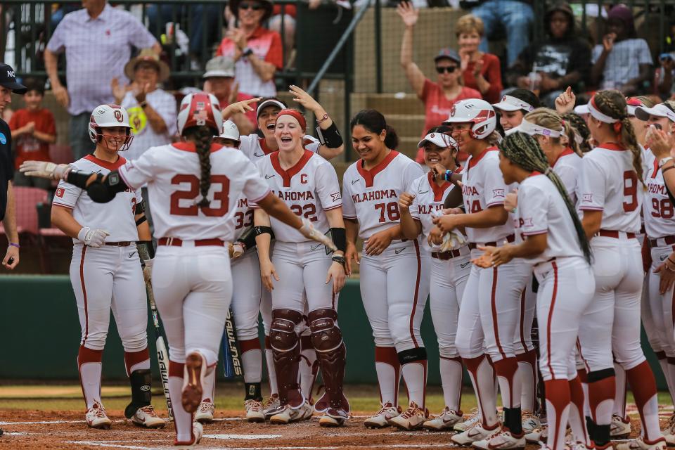 Tiare Jennings (23) hits a home run and is greeted by the team at home as the Oklahoma Sooners face the Prairie View A&M Panthers in the NCAA Norman Regional at Marita Hynes Field in Norman, Oklahoma, on Friday, May 20, 2022.