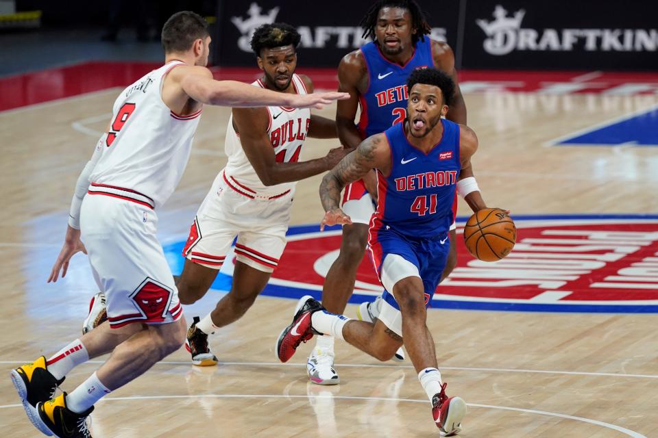 Detroit Pistons forward Saddiq Bey (41) controls the ball as Chicago Bulls center Nikola Vucevic (9) defends during the first half of an NBA basketball game, Sunday, May 9, 2021.