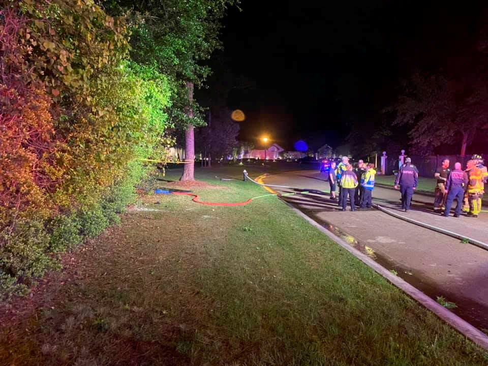 Emergency services personnel stand near the site of a Tesla vehicle crash in The Woodlands, Texas (via REUTERS)