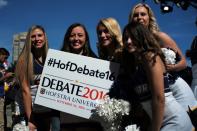 Cheerleaders pose with a sign before US Democratic presidential nominee Hillary Clinton and her Republican counterpart Donald Trump take part in the first presidential debate at the Hofstra University, in Hempstead, New York, on September 26, 2016