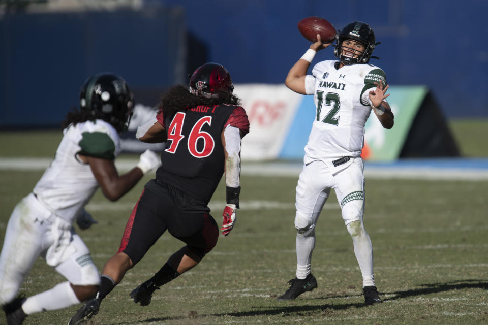 Hawaii quarterback Chevan Cordeiro, right, throws a pass during the first half of an NCAA college football game against San Diego State Saturday, Nov. 14, 2020, in Carson, Calif. (AP Photo/Kyusung Gong)