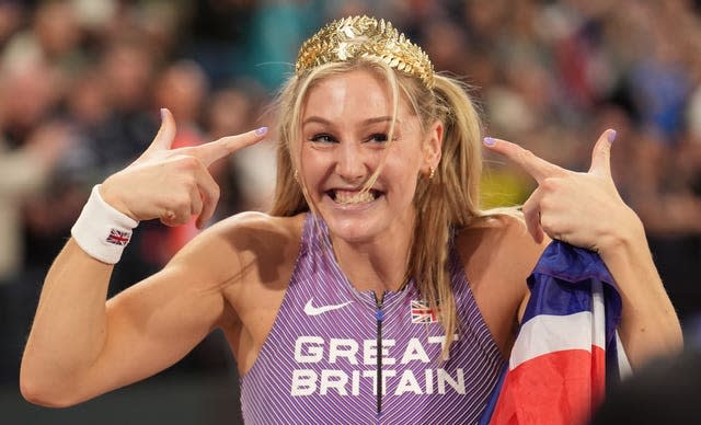 Molly Caudalie celebrates her victory, smiling and pointing to her head
