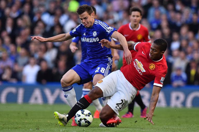 Manchester United's Antonio Valencia (R) challenges Chelsea's Cesar Azpilicueta during their English Premier League match, at Stamford Bridge in London, on April 18, 2015