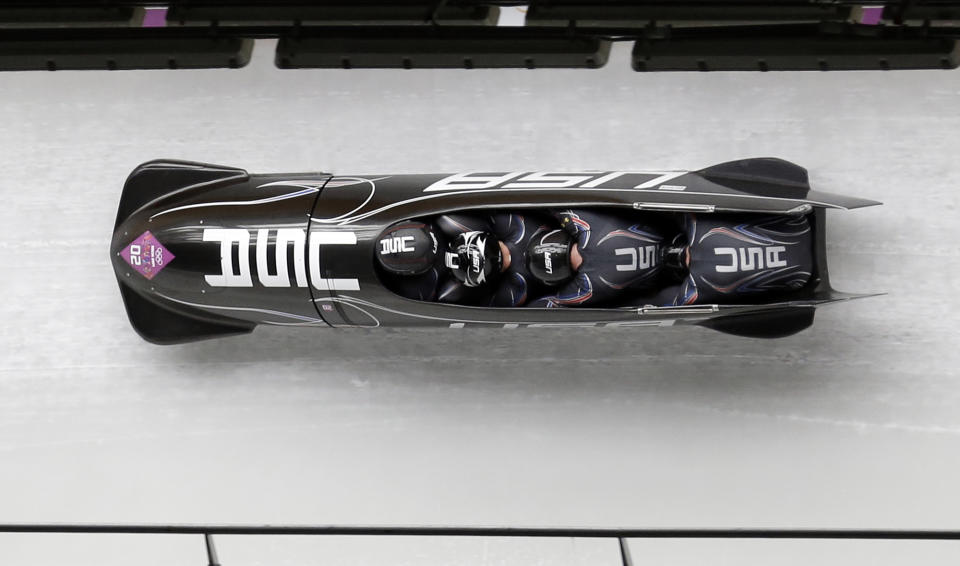 The team from the United States USA-1, with Steven Holcomb, Curtis Tomasevicz, Steven Langton and Christopher Fogt, take a curve in the second run during the men's four-man bobsled competition at the 2014 Winter Olympics, Saturday, Feb. 22, 2014, in Krasnaya Polyana, Russia. (AP Photo/Natacha Pisarenko)