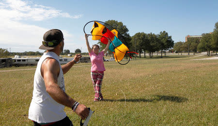 Brandon and Crystal Davis from Myakka, Florida try to get a kite to fly at Atlanta Motor Speedway where they were riding out Hurricane Irma in Hampton, Georgia, U.S., September 10, 2017. REUTERS/Tami Chappell