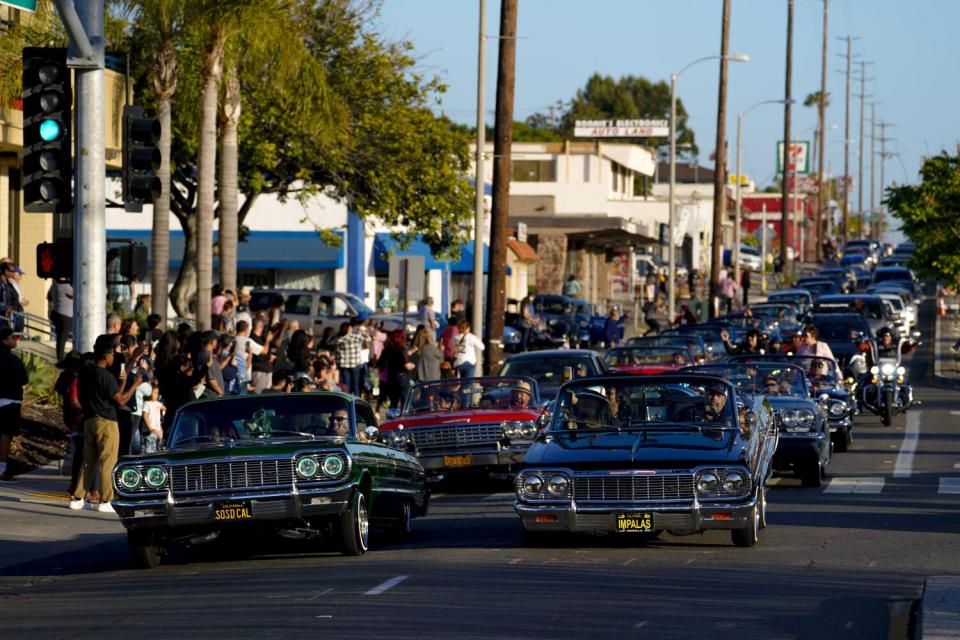 National City, CA - May 06: Customized lowriders cruise down Highland Avenue on Friday, May 6, 2022 in National City, CA.