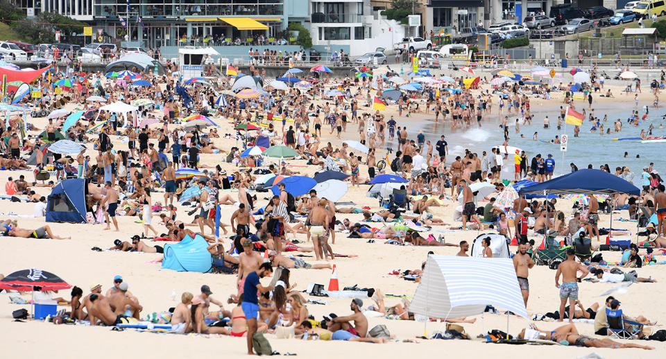 Hundreds of people swim and sunbake at Bondi Beach in Sydney.