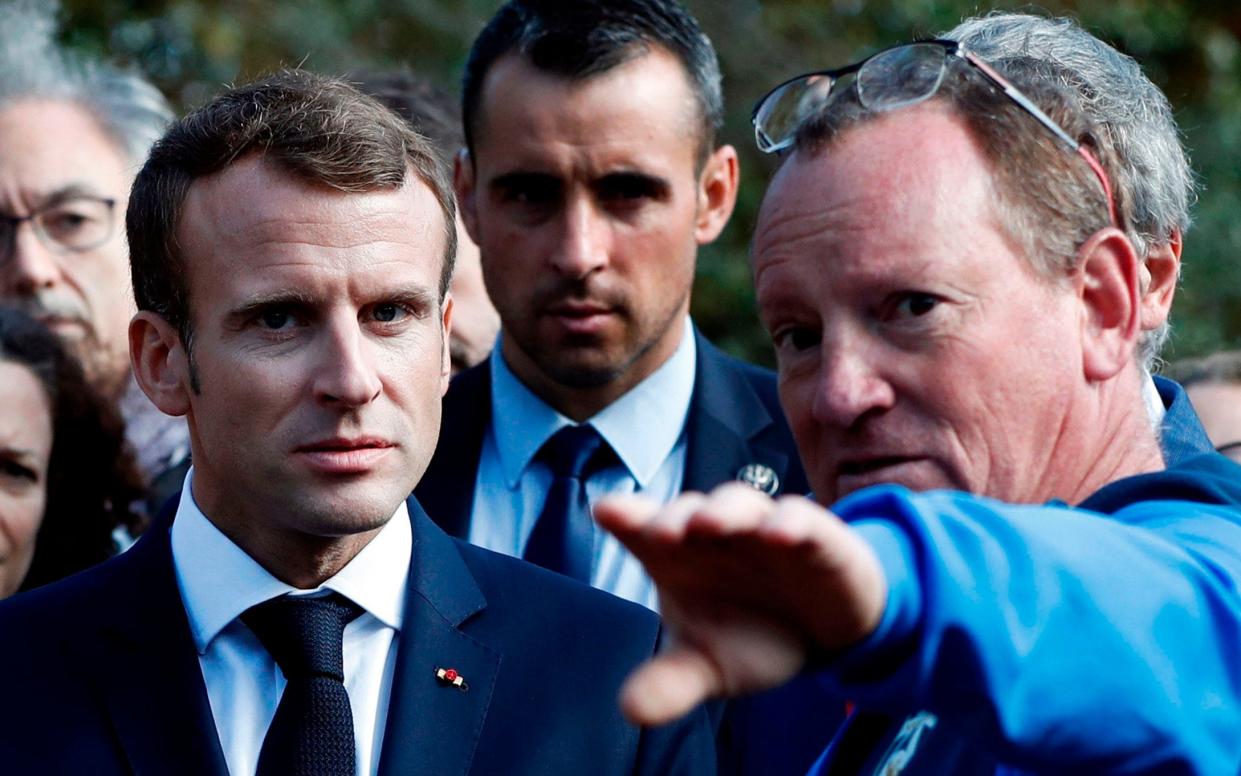 President Macron, left, meets residents of the flooded Aude department on Monday - AFP