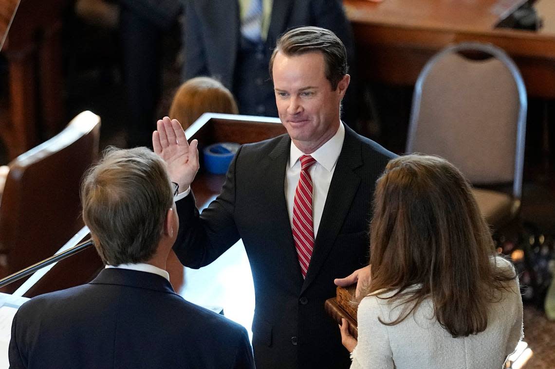 Speaker of the House Dade Phelan, R-Beaumont, center, stands with his wife Kim, right, as he is sworn in as Speaker of the House by Judge Jeff Branick, left, during the first day of the 88th Texas Legislative Session in Austin, Texas, Tuesday, Jan. 10, 2023. (AP Photo/Eric Gay)