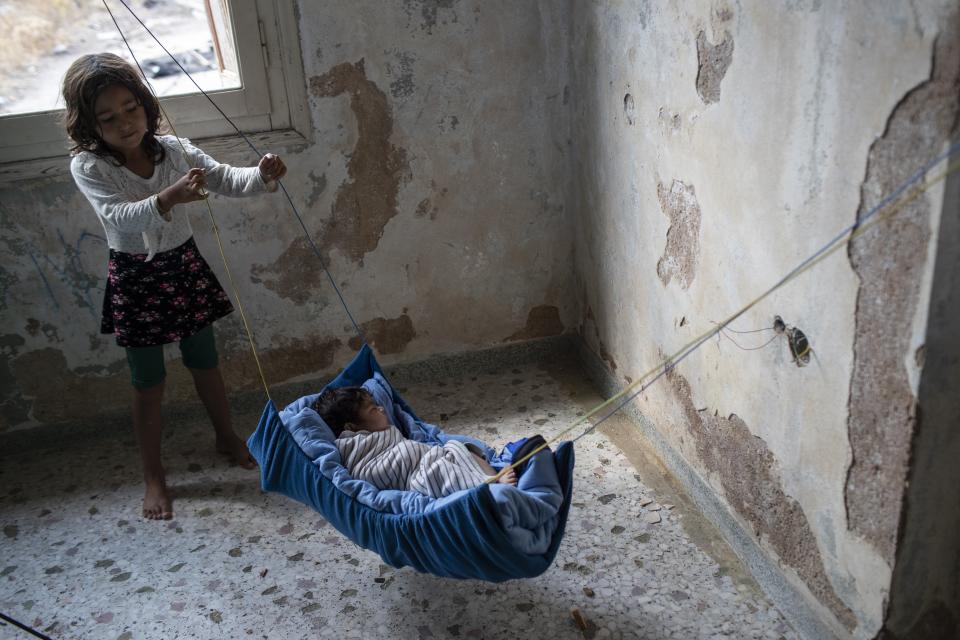 A two-month old baby from Afghanistan sleeps at an abandoned building near Mytilene town, on the northeastern island of Lesbos, Greece, Tuesday, Sept. 15, 2020. Just over 6% of people have been rehoused, following a recent fire that destroyed Greece's biggest camp for refugees and migrants making 12,500 people homeless, in a new temporary facility under construction on the island of Lesbos. (AP Photo/Petros Giannakouris)