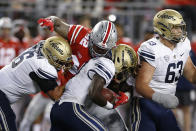 Ohio State defensive lineman Haskell Garrett, top, sacks Akron quarterback DJ Irons, center, during the first half of an NCAA college football game Saturday, Sept. 25, 2021, in Columbus, Ohio. (AP Photo/Jay LaPrete)