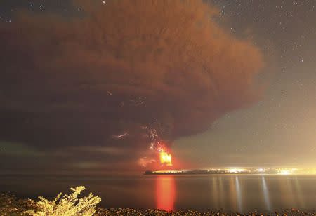 Smoke and lava spew from Calbuco, as seen from the shores of Lake Llanquihue in Puerto Varas. REUTERS/Carlos Gutierrez