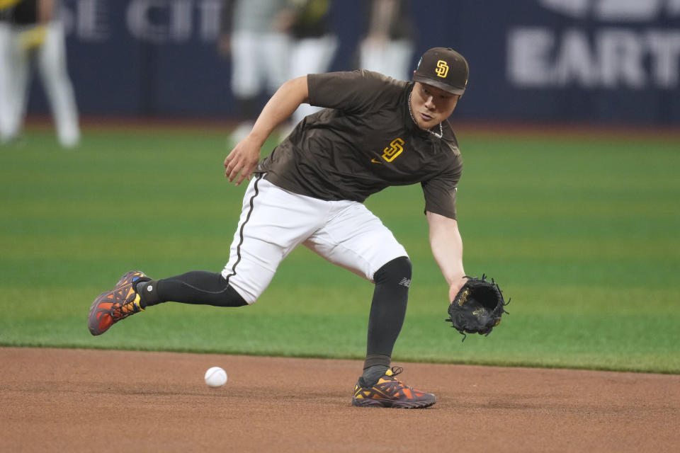 San Diego Padres Ha-Seong Kim fields a ground ball during a baseball workout at the Gocheok Sky Dome in Seoul, South Korea, Tuesday, March 19, 2024. Major League Baseball's season-opening games between the Los Angeles Dodgers and San Diego Padres in Seoul will be the first MLB games held in the baseball-loving nation.(AP Photo/Lee Jin-man)