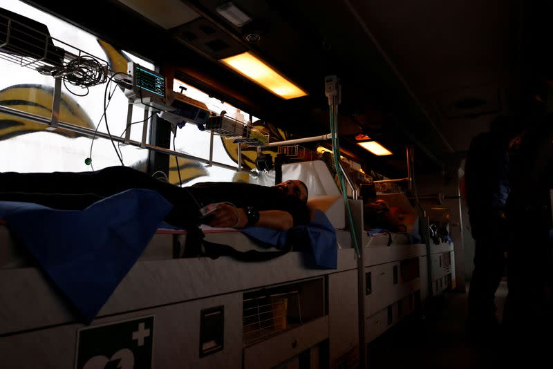 Ukrainian volunteer medics use a converted bus to transport wounded Ukrainian soldiers from the eastern frontline near Bakhmut to a hospital in Dnipro