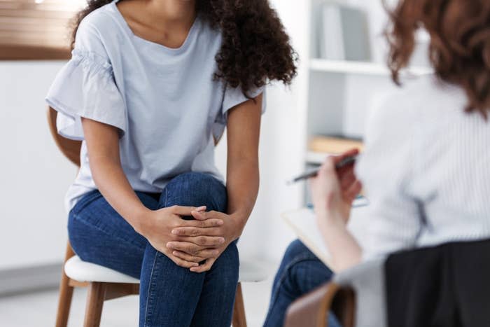 A woman sits in therapy