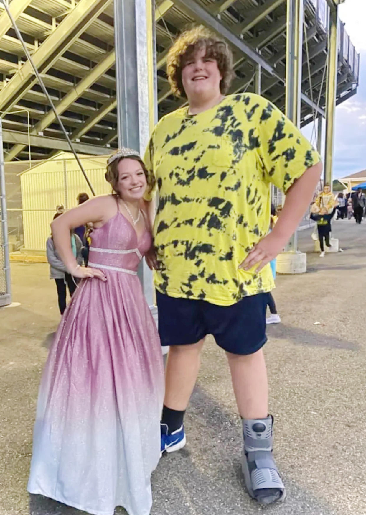 Eric Jr. posed with his friend Ashlynn at homecoming. He sprained his ankle playing football — an injury that likely could have been avoided if he had cleats.  (Courtesy Rebecca Kilburn)