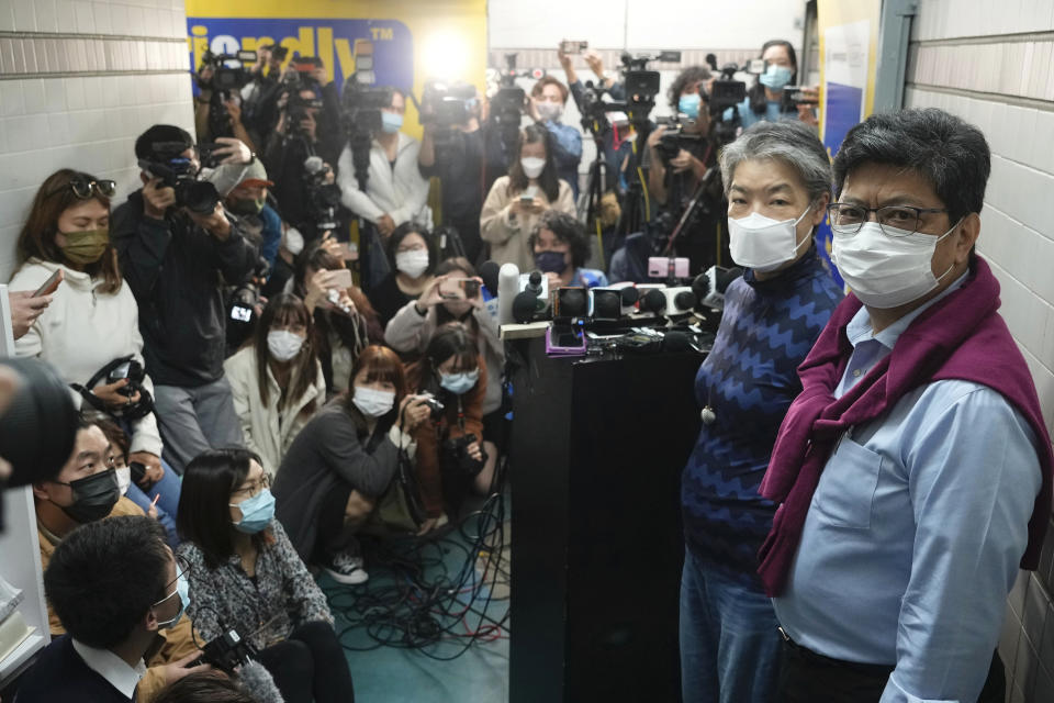 CORRECTS YEAR - Citizen News' founder and chief writer Chris Yeung, right, and chief editor Daisy Li, second right, pose before a press conference outside their office in Hong Kong Monday, Jan. 3, 2022. The Hong Kong online news site said Sunday that it would cease operations in light of deteriorating press freedoms, days after police raided and arrested seven people for sedition at a separate pro-democracy news outlet. Citizen News announced its decision in a Facebook post Sunday. It said it would stop updating its site on Jan. 4, and it would be shuttered after that. (AP Photo/Vincent Yu)