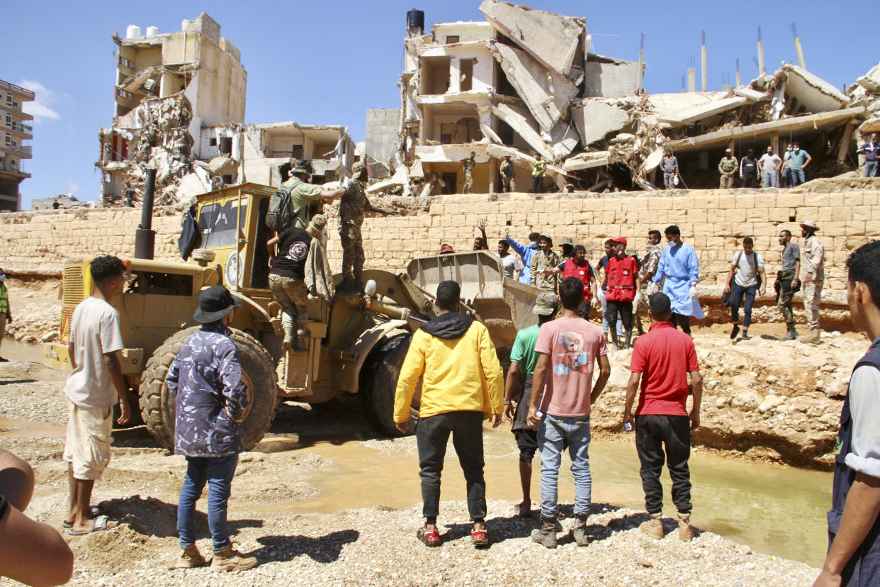 Search teams are combing streets, wrecked buildings, and even the sea to look for bodies in Derna, where the collapse of two dams unleashed a massive flash flood that killed thousands of people.  (Yousef Murad / AP)