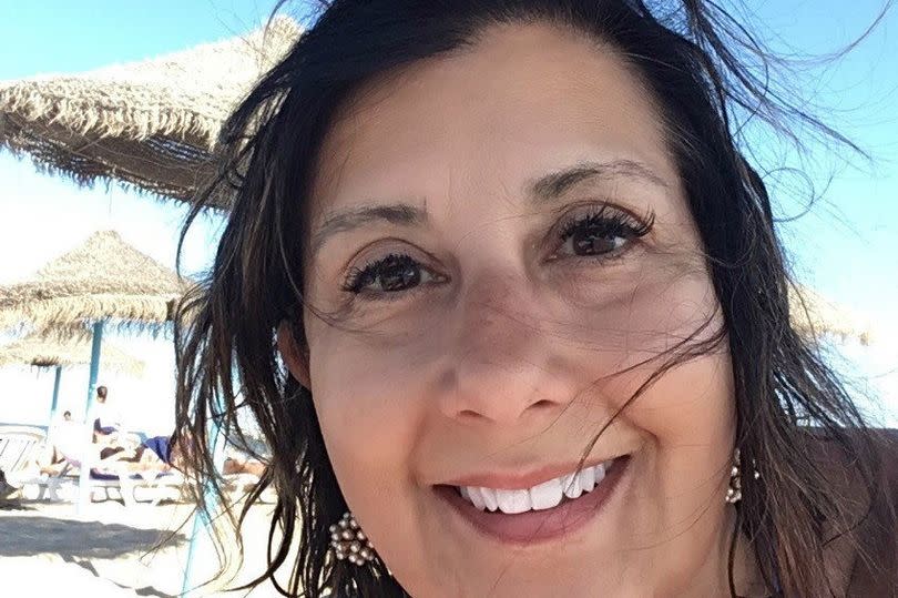 Headshot of a woman lying on a beach