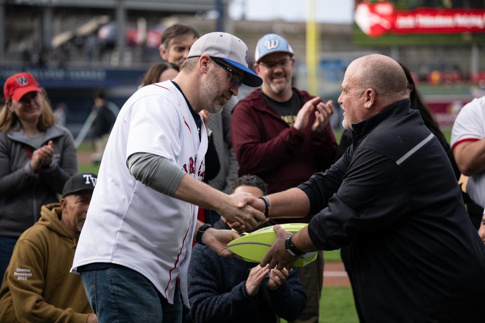 Chad Dawkins receives an automated external defibrillator machine on behalf of The Jesse Burkett Little League from Ralph Thibodeau at Polar Park on Friday. Thibodeau tragically lost his son Josh to cardiac arrest during a soccer camp in 2011.