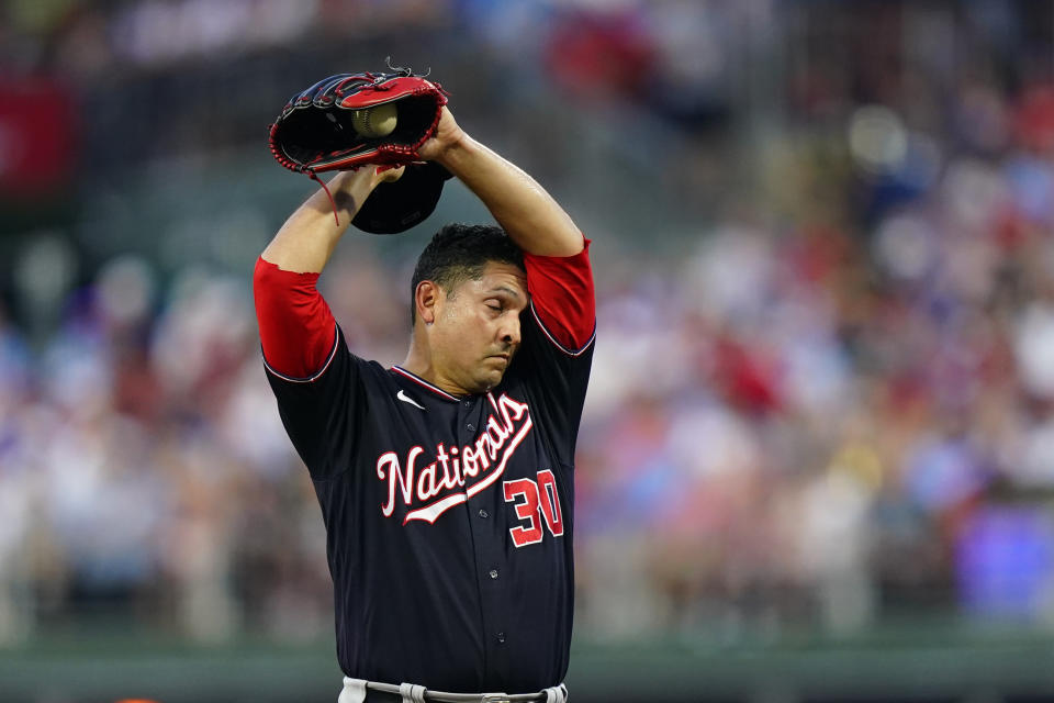 Washington Nationals' Paolo Espino wipes his brow during the first inning of a baseball game against the Philadelphia Phillies, Thursday, Aug. 4, 2022, in Philadelphia. (AP Photo/Matt Rourke)