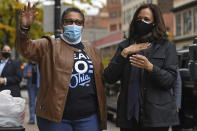 FILE - In this Oct. 24, 2020, file photo Democratic vice presidential candidate Sen. Kamala Harris, D-Calif. and Rep. Marcia Fudge, D-Ohio wave to employees of Zanzibar Soul Fusion restaurant during a campaign event in Cleveland. At Agriculture and the Department of Housing and Urban Development, Fudge and California Rep. Karen Bass, respectively, are being considered by President-elect Joe Biden to be a part of the administration. (AP Photo/David Dermer, File)