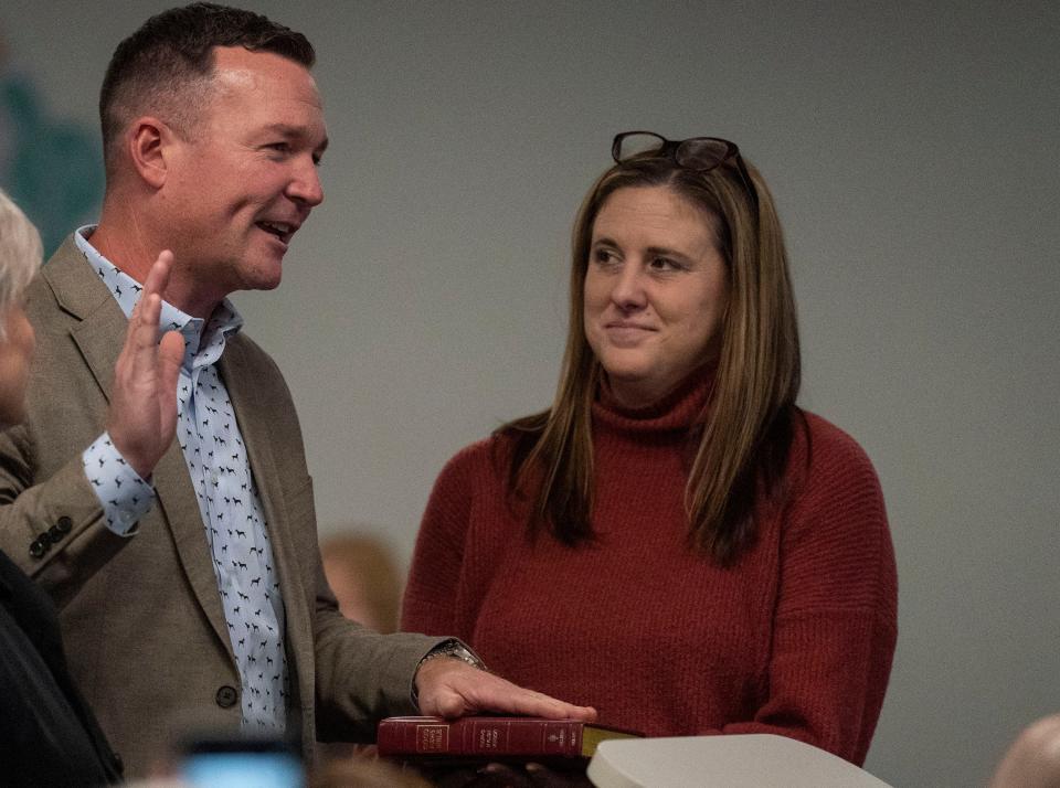 Newly-elected board member Rick Haring, left, gets sworn-in with his wife Rebecca Cartee-Haring, right, at his side at the Central Bucks School District Board re-org in Doylestown on Monday, Dec. 4, 2023.

[Daniella Heminghaus | Bucks County Courier Times]