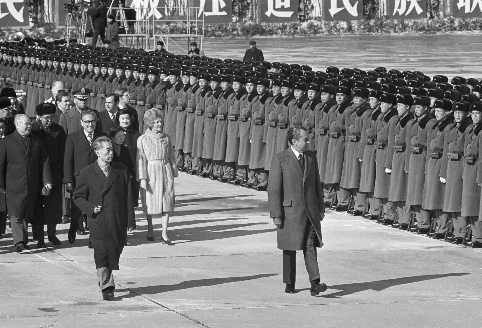 FILE - Henry Kissinger, third from left walks behind then U.S. President Nixon and China's Premier Chou En-Lai as they review troops at the Beijing Airport Saturday, Feb. 26, 1972. Official China called Kissinger “an old friend.” A commentator likened him to a giant panda, a goodwill ambassador between two countries that have been more often at odds over the decades than not. Kissinger, who died Wednesday, Nov. 29, 2023, developed a special relationship with China in the second half of his 100-year-long life.(AP Photo, File)