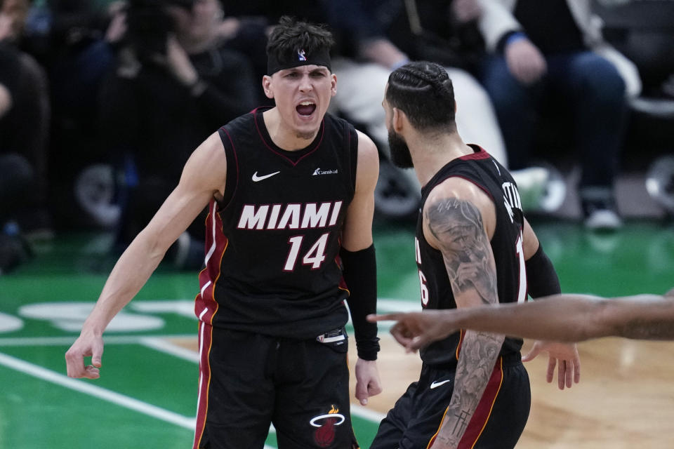 Miami Heat guard Tyler Herro (14) celebrates with Caleb Martin late in the second half Game 2 of the team's NBA basketball first-round playoff series against the Boston Celtics, Wednesday, April 24, 2024, in Boston. (AP Photo/Charles Krupa)