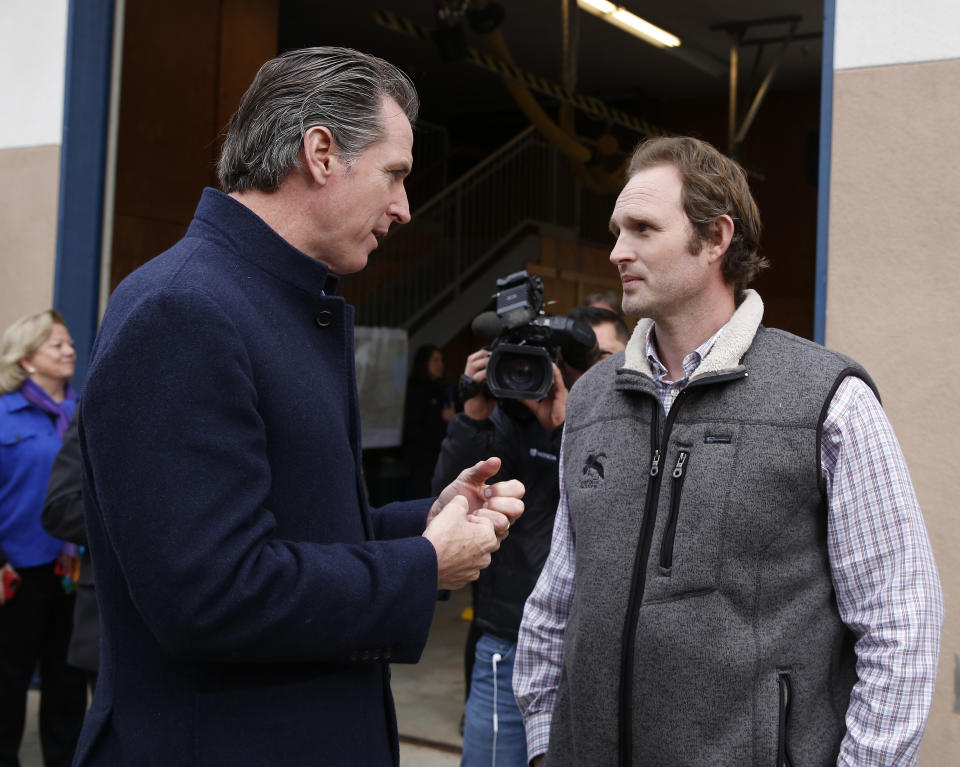 Gov. Gavin Newsom, left, talks with Assemblyman James Gallagher, R-Yuba City, about emergency preparedness during a visit to the California Department of Forestry and Fire Protection CalFire Colfax Station Tuesday, Jan. 8, 2019, in Colfax, Calif. On his first full day as governor, Newsom announced executive actions to improve the state's response to wildfires and other emergencies. Several communities in Gallagher's district have been hit hard by recent wildfires. (AP Photo/Rich Pedroncelli)