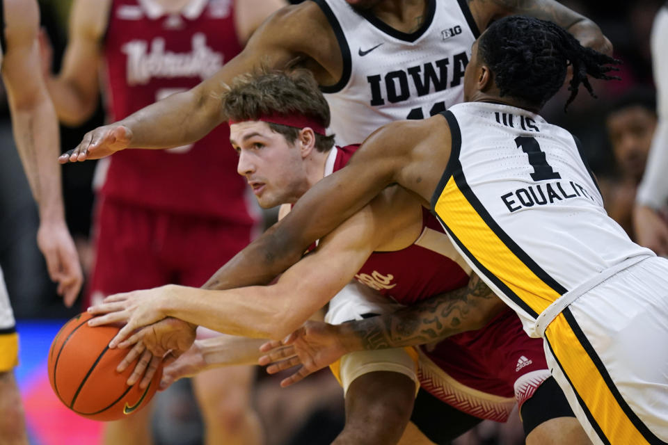 Nebraska guard Sam Hoiberg is fouled by Iowa guard Ahron Ulis, right, during the second half of an NCAA college basketball game, Sunday, March 5, 2023, in Iowa City, Iowa. Nebraska won 81-77. (AP Photo/Charlie Neibergall)