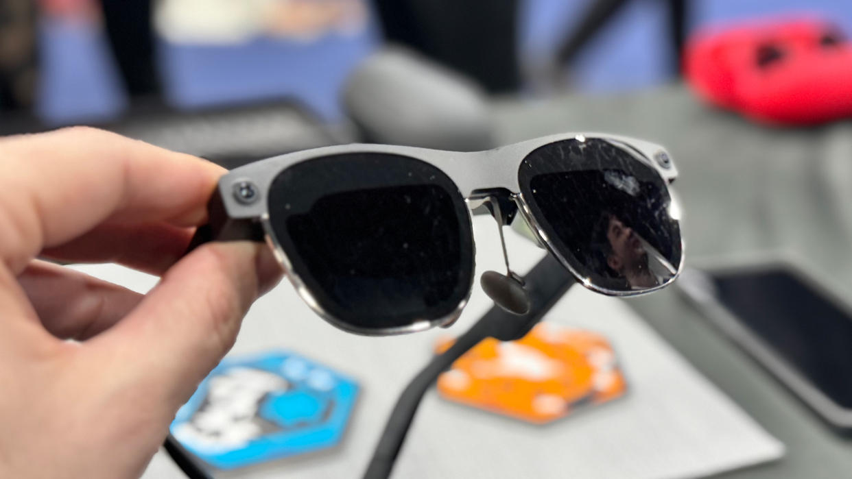  XREAL Air 2 Ultra XR glasses held over a table at CES 2024. 