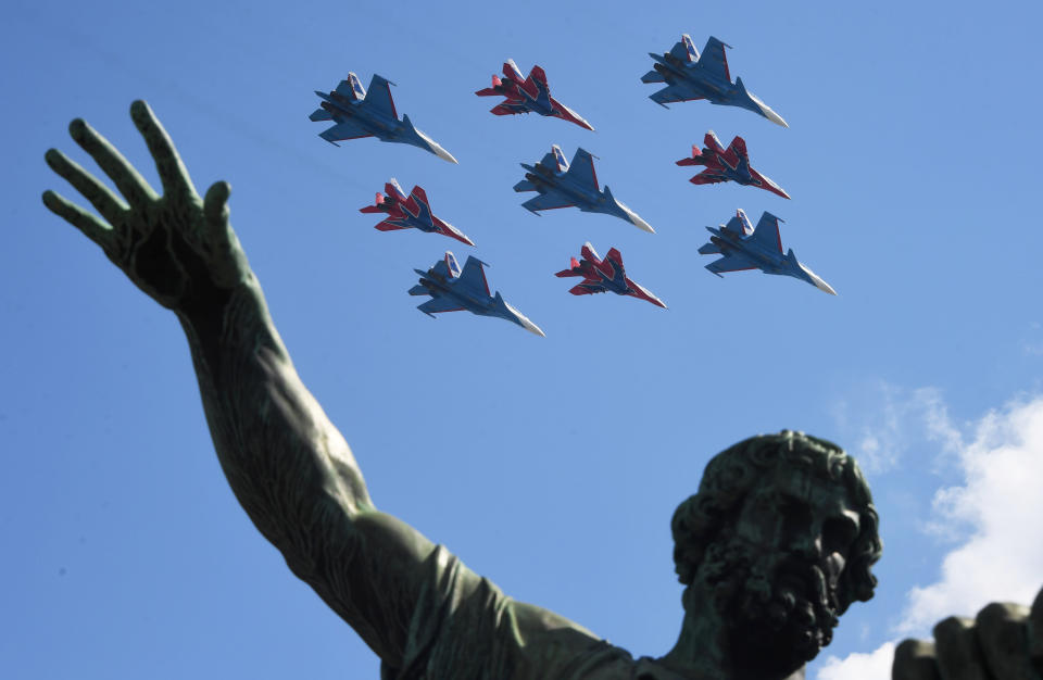 Russian Knights (Russkiye Vityazi) and Strizhi (Swifts) aerobatic teams fly their Sukhoi Su-30SM and Mikoyan MiG-29 fighter jets over Red Square during the Victory Day military parade marking the 75th anniversary of the Nazi defeat in Moscow, Russia, Wednesday, June 24, 2020. The Victory Day parade normally is held on May 9, the nation's most important secular holiday, but this year it was postponed due to the coronavirus pandemic. (Iliya Pitalev, Host Photo Agency via AP)