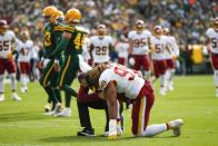 Washington Football Team's Chase Young is helped after being shaken up during the first half of an NFL football game against the Green Bay Packers Sunday, Oct. 24, 2021, in Green Bay, Wis. (AP Photo/Matt Ludtke)