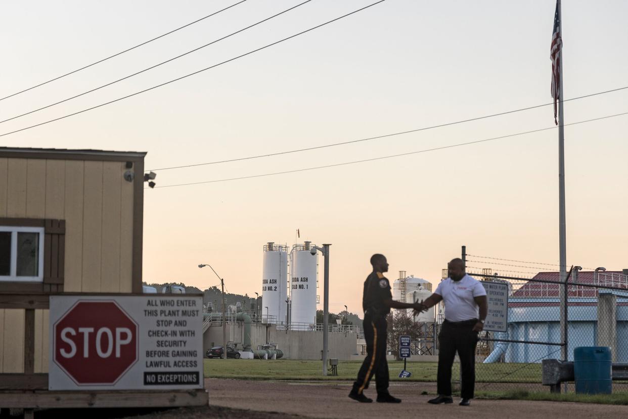 Security personnel greet each other outside of the O.B. Curtis Water Treatment Plant on August 31, 2022 in Jackson, Mississippi. Jackson, Mississippi, the state’s capital, is currently struggling with access to safe drinking water after disruption at a main water processing facilty.