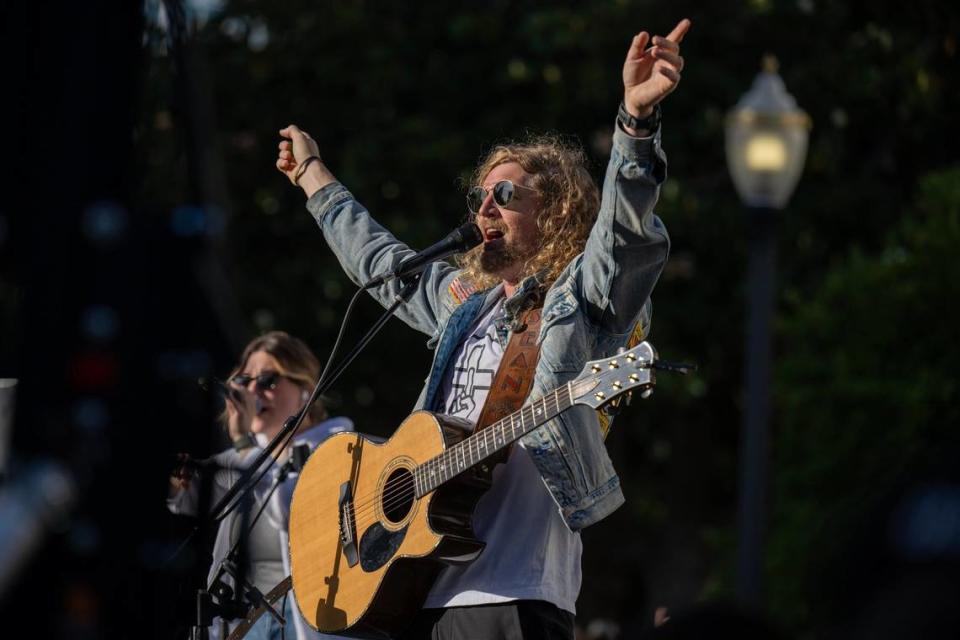 Christian faith leader and musician Sean Feucht speaks to the attendees of his Let Us Worship rally in Sacramento on Saturday.