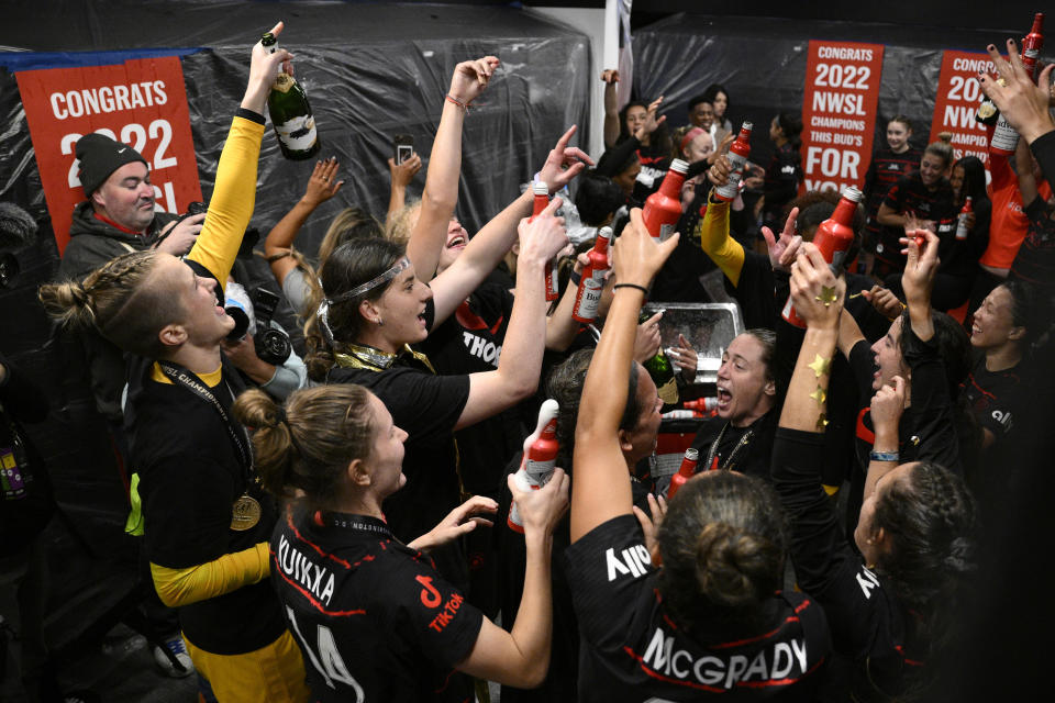 The Portland Thorns FC celebrate in the locker room after the NWSL championship soccer match against the Kansas City Current, Saturday, Oct. 29, 2022, in Washington. Portland won 2-0. (AP Photo/Nick Wass)