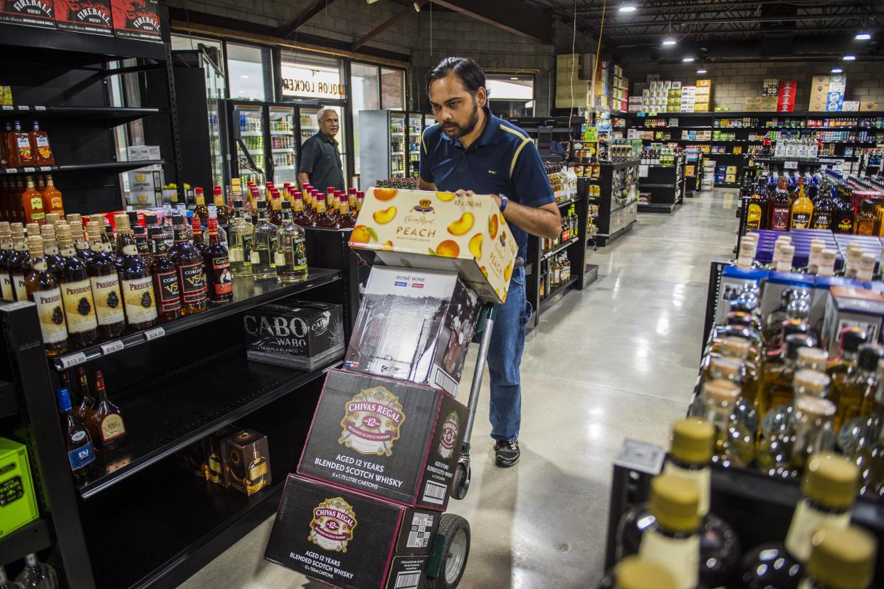 Pranav Patel, manager of Augusta Beverage Center, rolls out boxes of liquor to stock shelves, in this photo from August 25, 2020. The Columbia County Board of Commissioners voted unanimously Tuesday to make its rules more stringent regarding the establishment of new package stores.